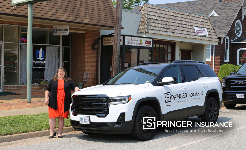 A smiling Peggy with the new company Car